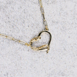 Amo necklace, close-up of the heart and serpent pendant