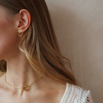 Amo earrings worn as part of a matching set with the necklace