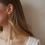 Amo earrings worn as part of a matching set with the necklace