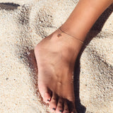Ular serpent anklet in sterling silver, resting on the ankle