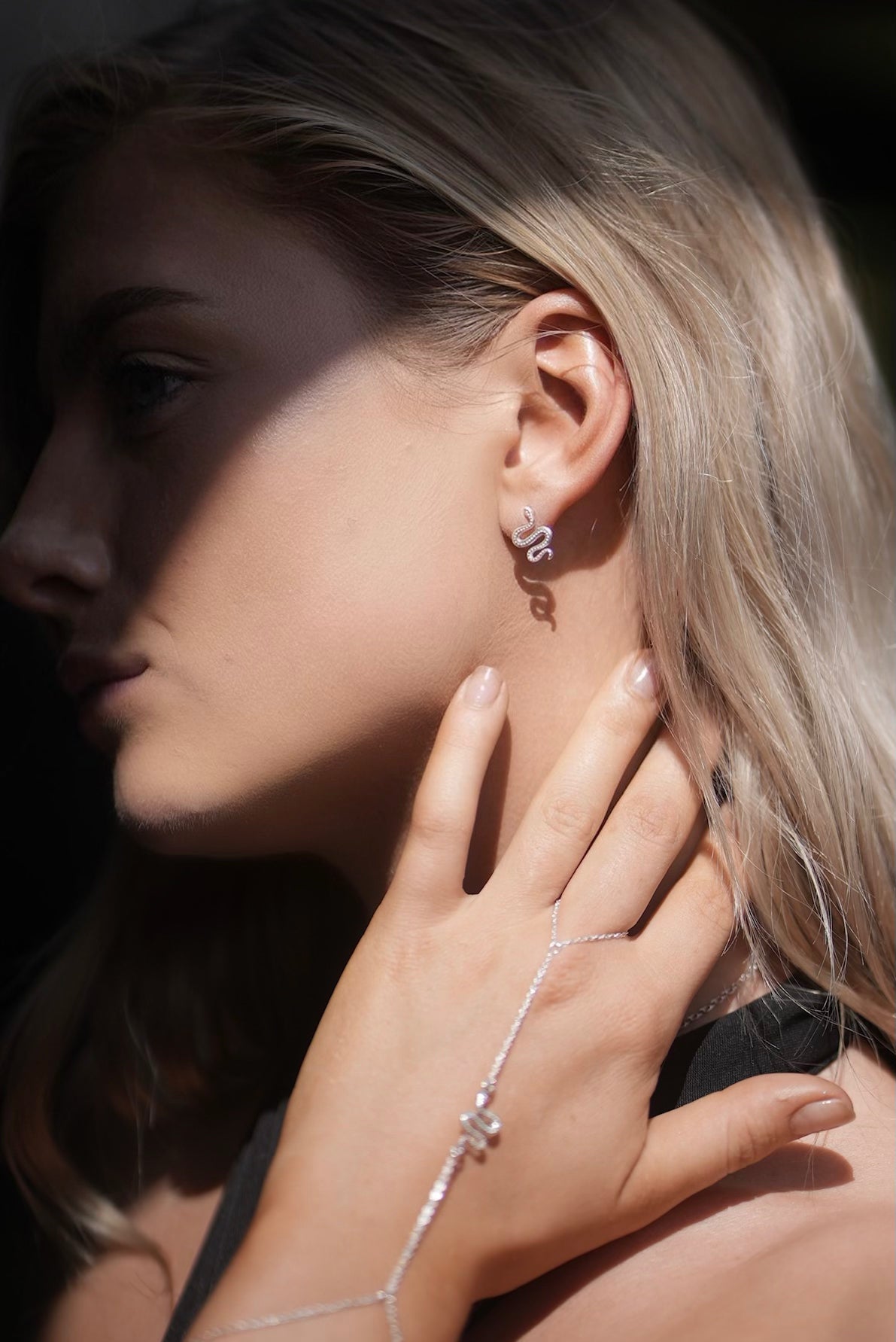 Ular serpent earrings in sterling silver, sculptural curved detail