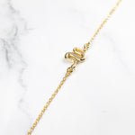 Ular serpent bracelet layered with heavier bracelets