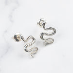 Ular serpent earrings, close-up of the curved silhouette