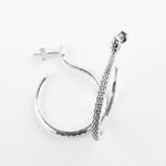 Sarpe serpent hoop earrings worn styled with an updo