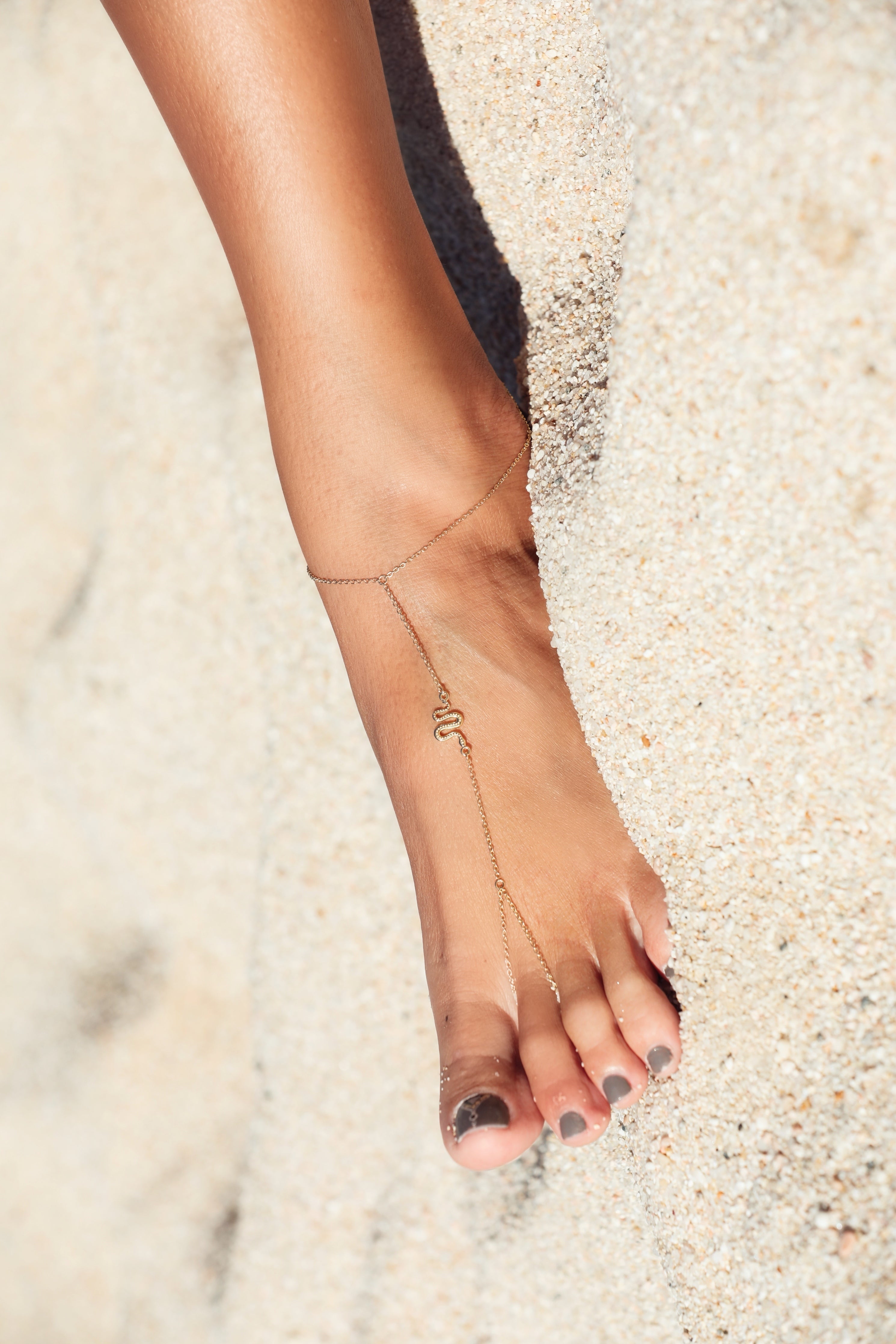 Nahesa serpent anklet in sterling silver, wrapped around the ankle