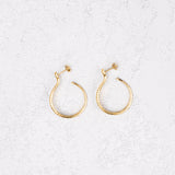 Sarpe serpent hoop earrings worn on bare skin, front view