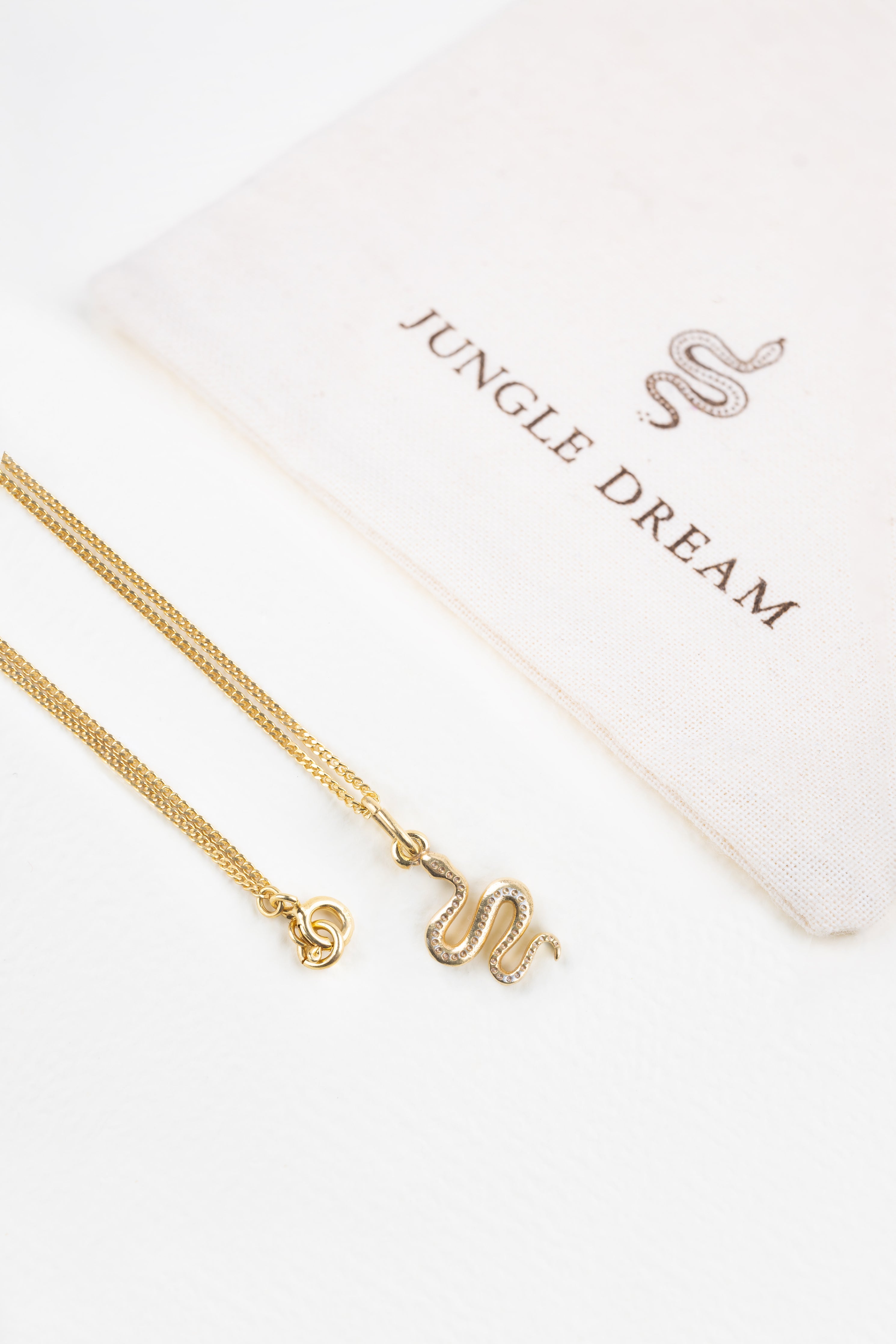 Ular necklace, close-up of the serpent silhouette pendant