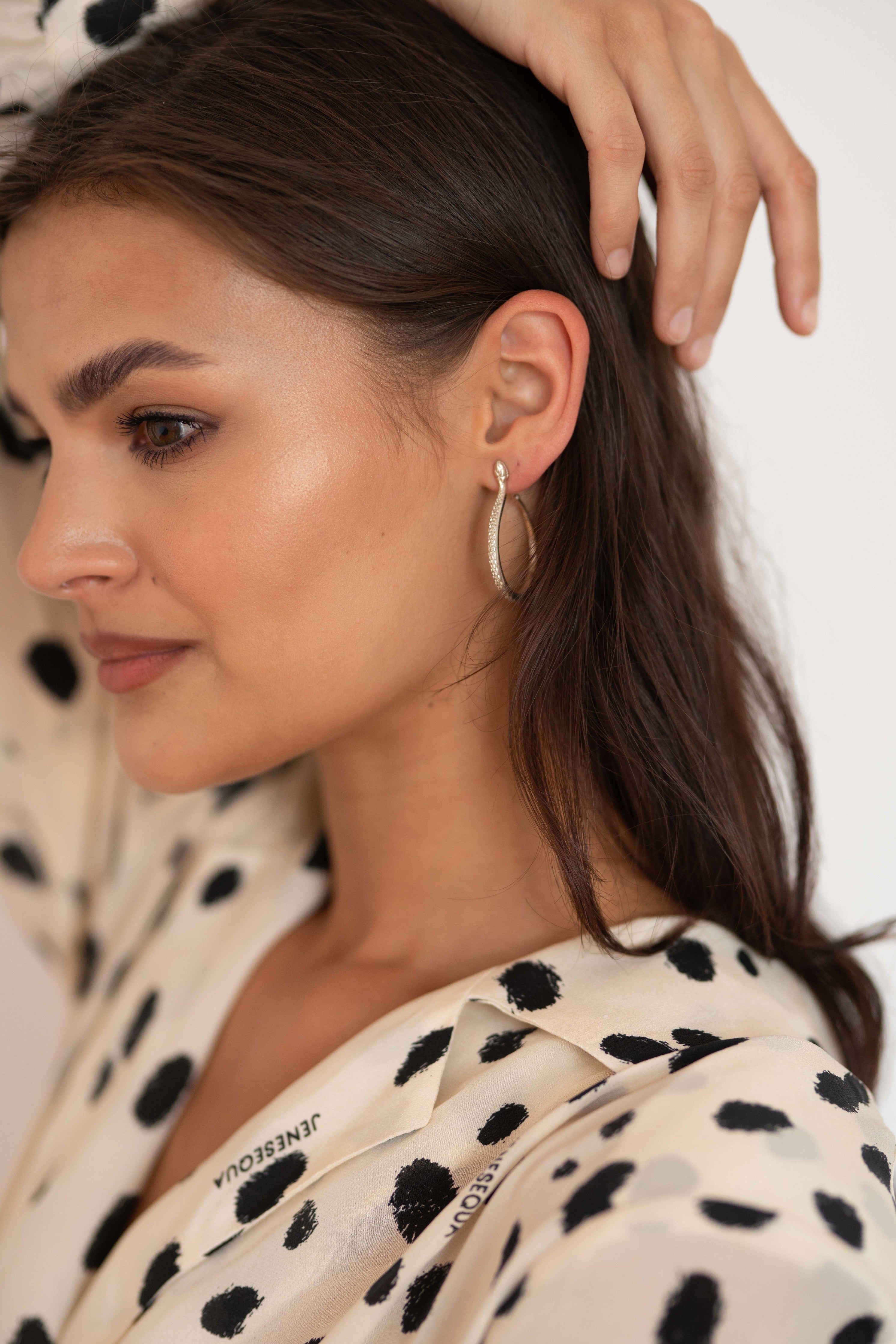 Sarpe serpent hoop earrings, product detail shot on neutral background