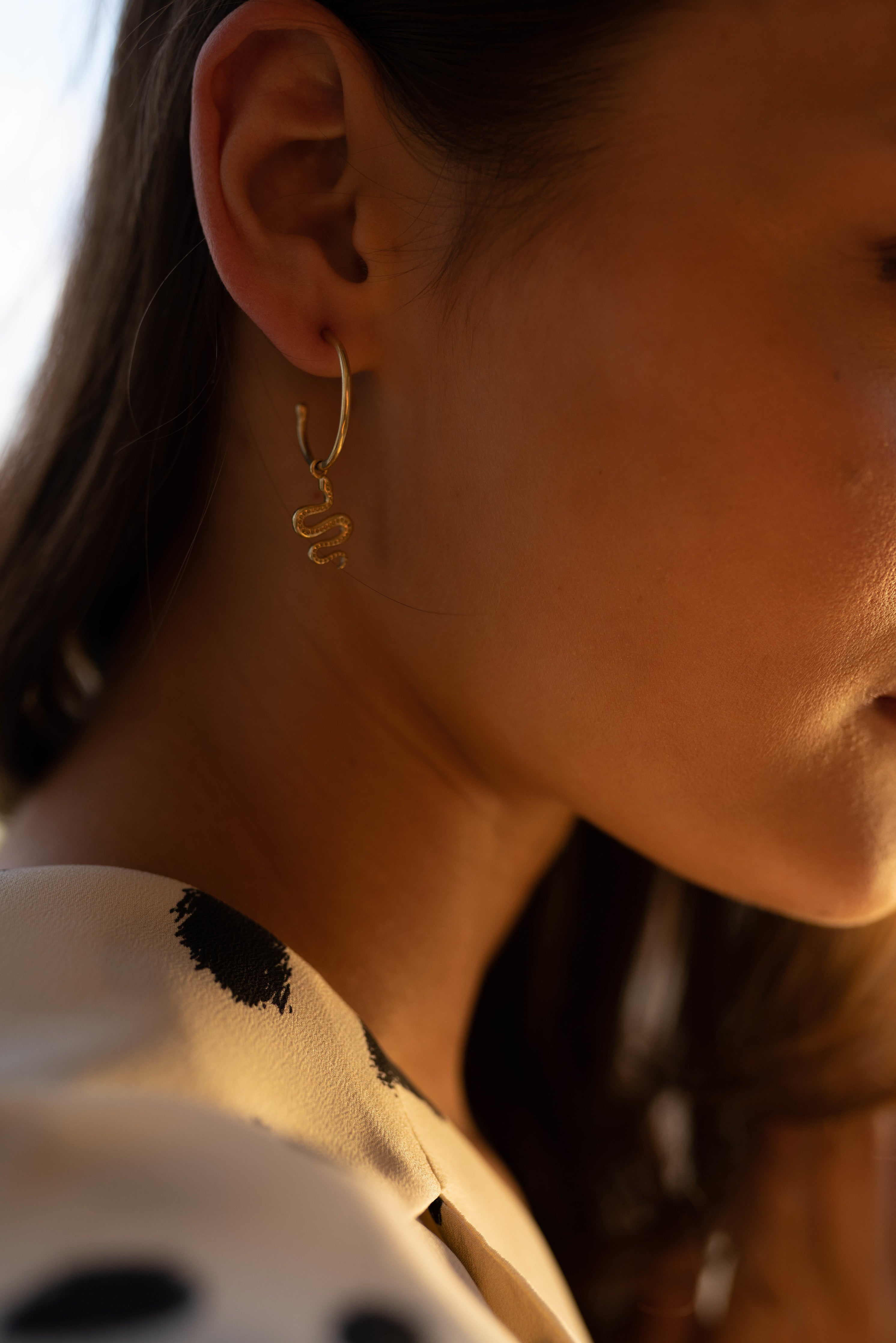 Ejo serpent earrings, product detail against a neutral background