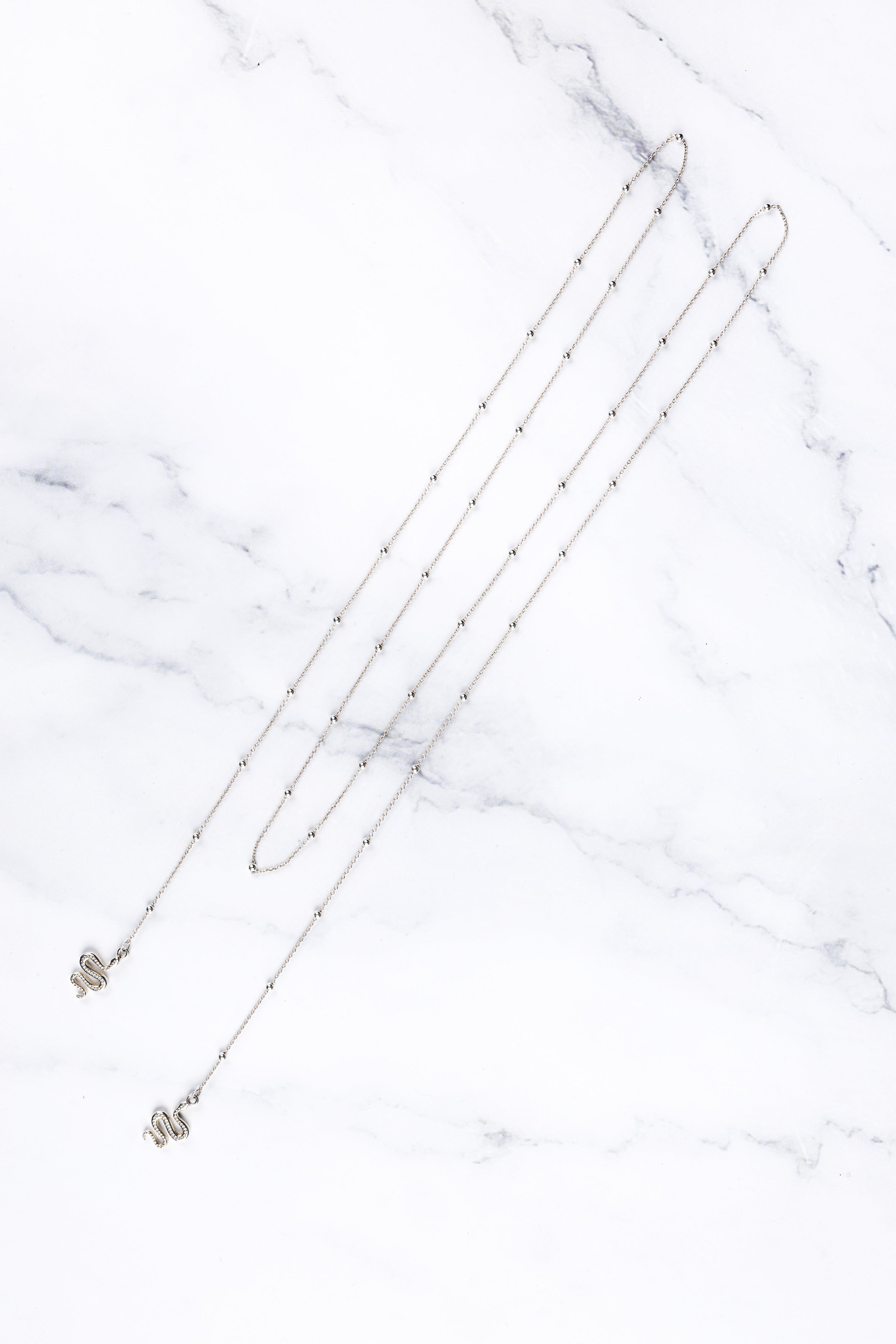 Tove face chain, close-up of the serpent detail at the ends